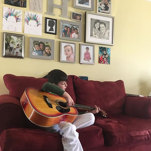 He wants to learn to play guitar and doesn’t seem to mind that it’s as big as he is. #rockstarinthemaking #boymom